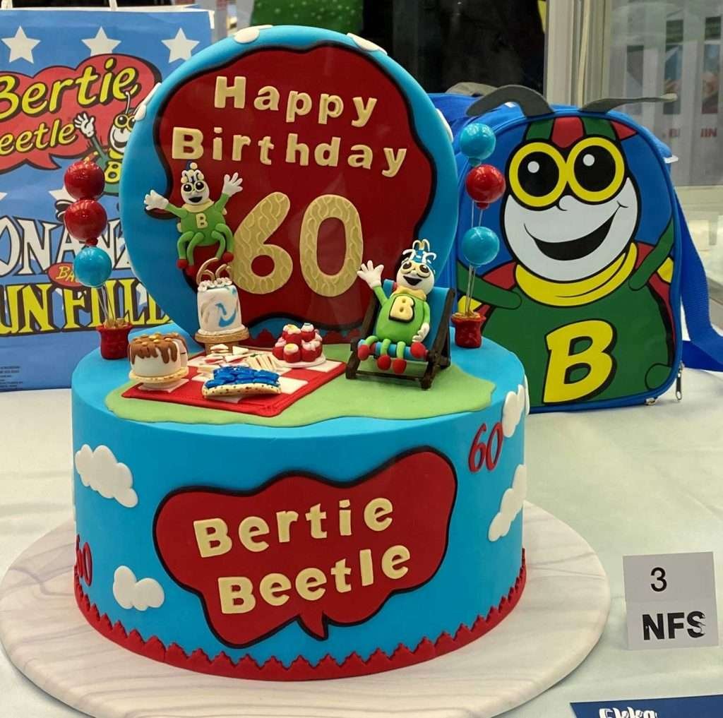 Bertie Beetle decorated cake with Happy Birthday 60 on top.